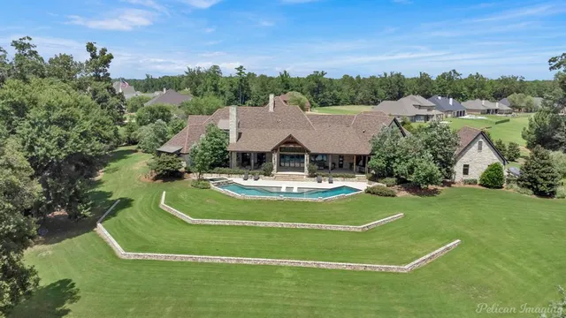 a view of a house with swimming pool and a yard