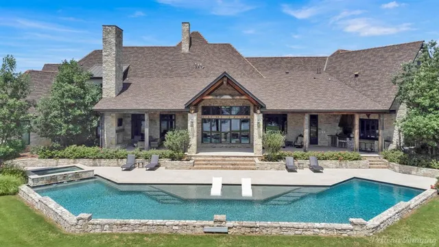 a living room with furniture fireplace and a large window