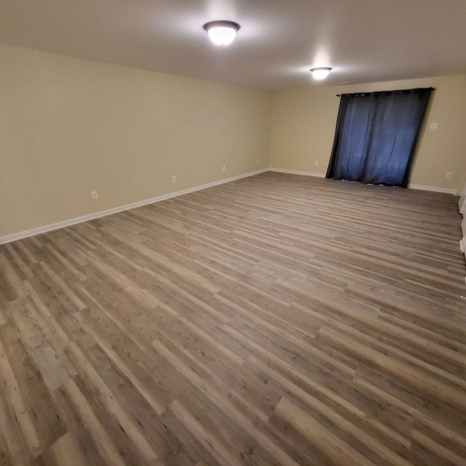 8 Perryfalls Place Nottingham, MD 21236 - Photo 19 of 23 Basement club room with modern flooring.