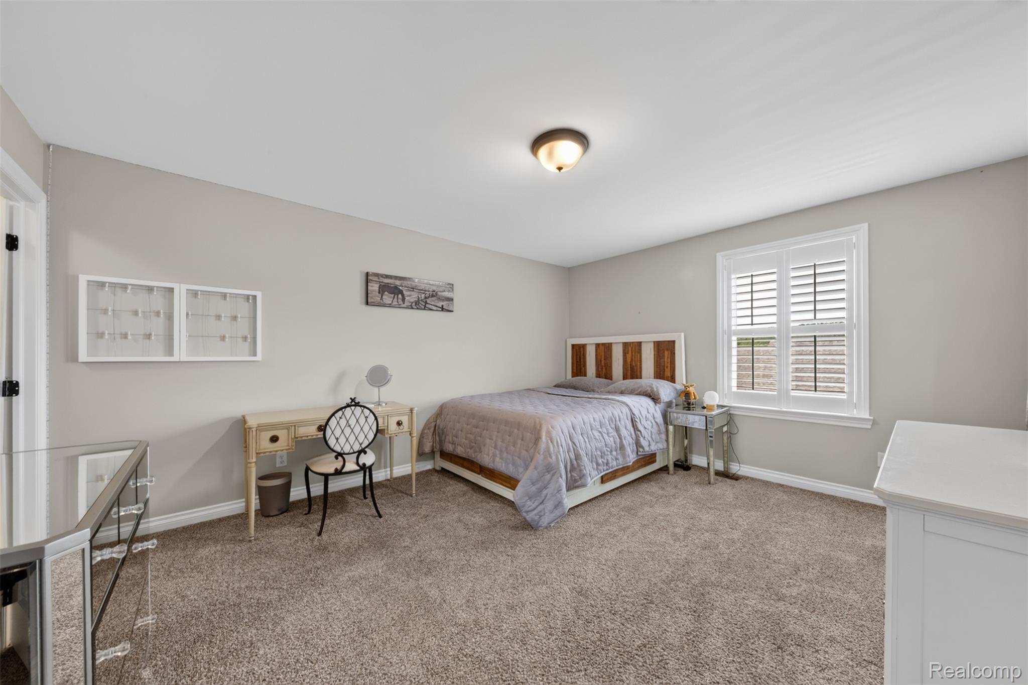 2531 Walnut View Drive Howell, MI 48855 - Photo 23 of 34 Carpeted room featuring a ceiling-mounted light fixture, a window with white plantation shutters, and light gray wall paint
