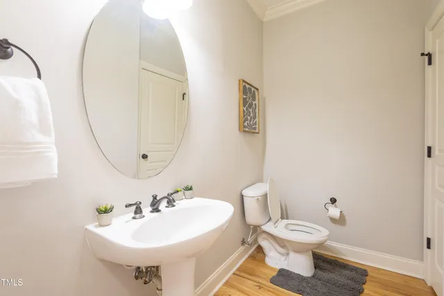 a bathroom with a sink toilet and a mirror