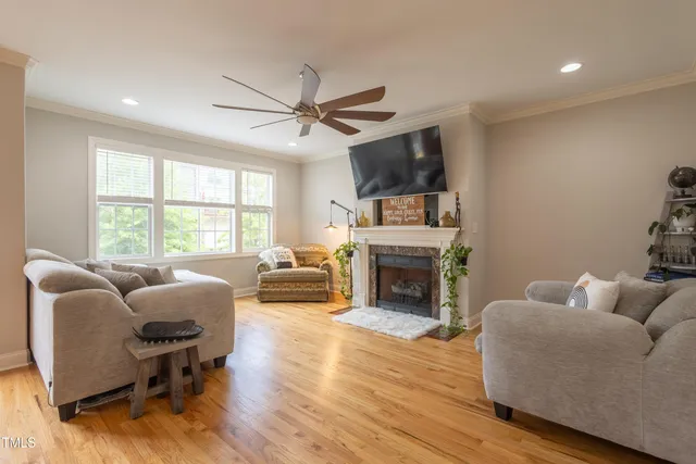 a living room with furniture a fireplace and a flat screen tv