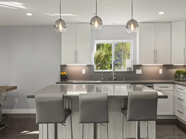 a large kitchen with kitchen island granite countertop a sink stove and refrigerator