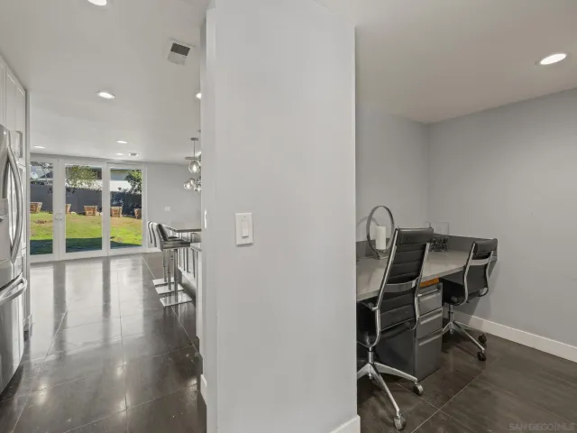 a kitchen with stainless steel appliances granite countertop a sink a stove a refrigerator and island with wooden floor