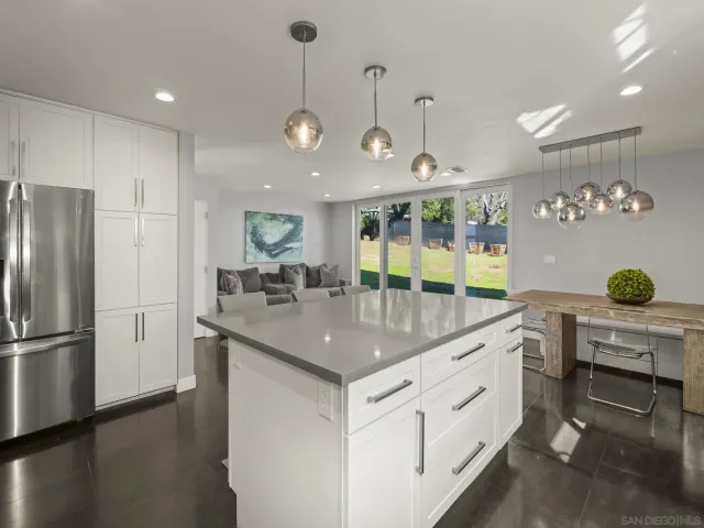 a bathroom with a granite countertop toilet sink and mirror
