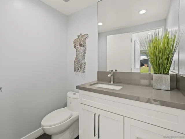 a living room with furniture and a lamp