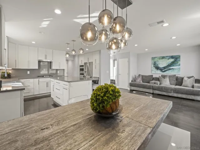 a kitchen with stainless steel appliances kitchen island granite countertop a stove a sink and a refrigerator