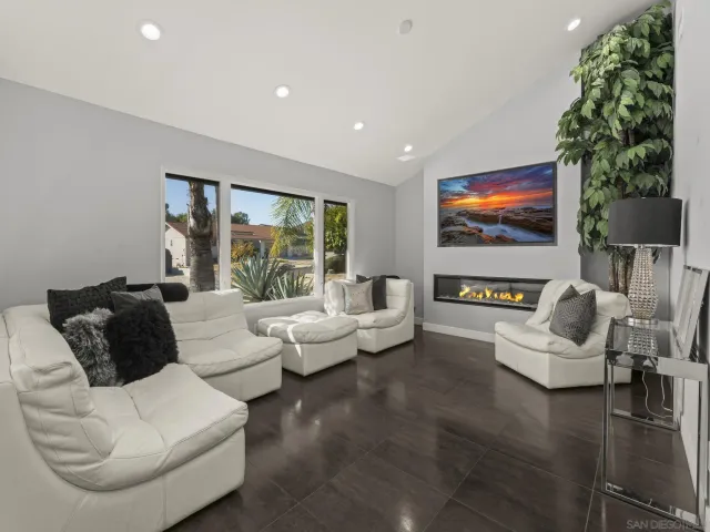 a bedroom with a bed and a flat tv screen on dresser
