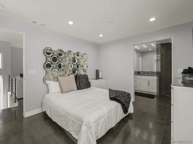 a bathroom with a granite countertop sink a mirror and a shower