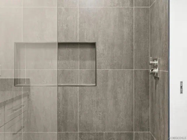 a bathroom with a shower and a sink