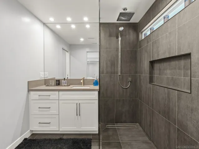 a bedroom with a bed and a large mirror