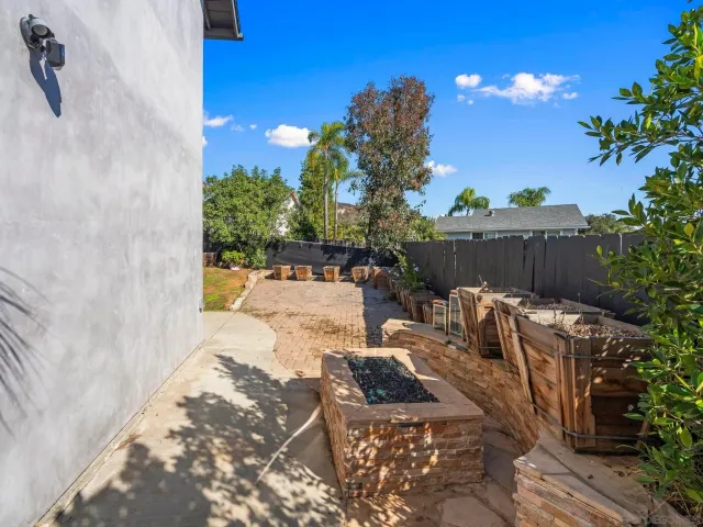 a bathroom with a granite countertop sink a toilet a mirror and shower