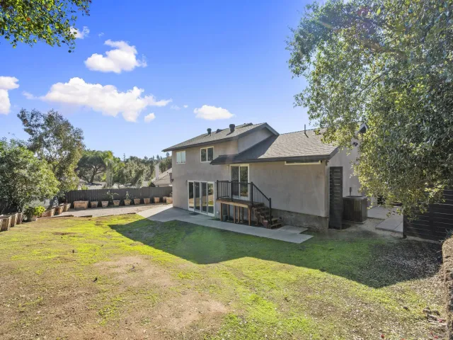 an aerial view of a house with a yard and a fountain