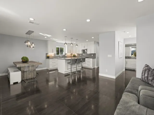a kitchen with a table chairs cabinets and window