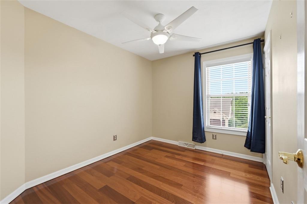 4003 Oak Point Circle McKees Rocks, PA 15136 - Photo 30 of 50 This bright secondary bedroom offers hardwood flooring, neutral tones, and flexible space for guests, a nursery, hobbies, or a work-from-home setup.
