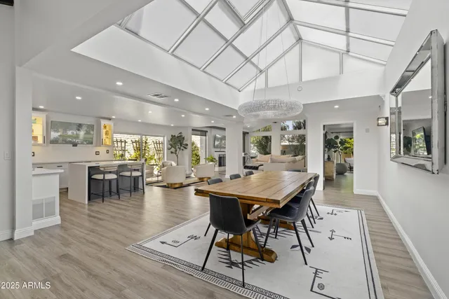 a living room with furniture fireplace and a large window