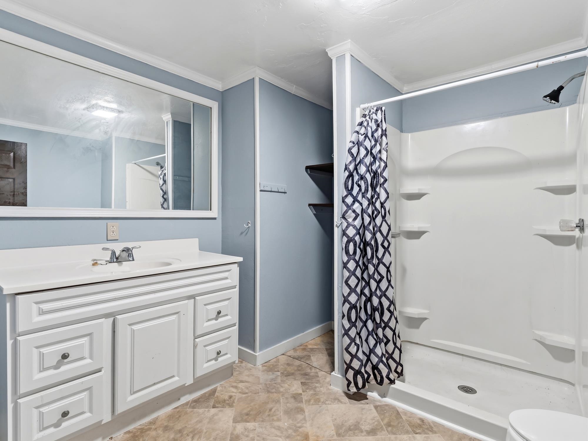 737 9th Street Port Arthur, TX 77640 - Photo 15 of 20 a bathroom with a sink a toilet and a shower
