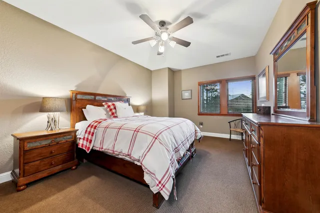 a bed room with a bed and a large window