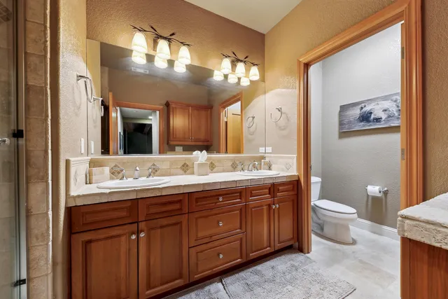 a bathroom with a double vanity sink and a mirror