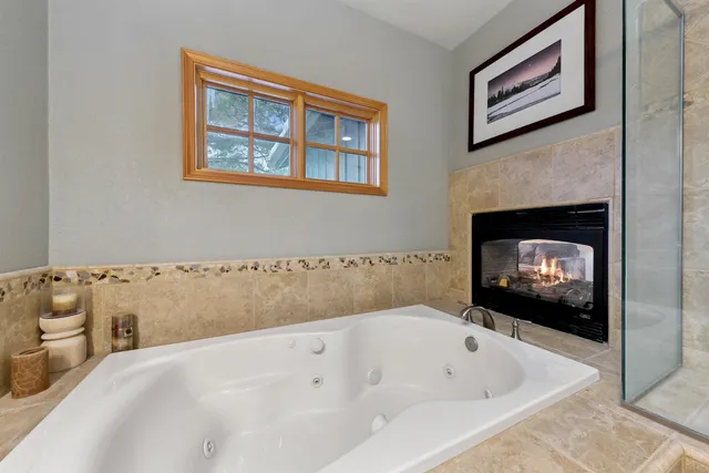a bathroom with a tub and a fireplace