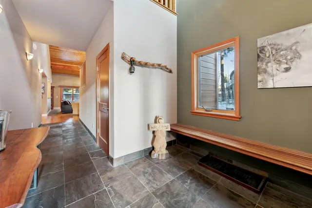 a hallway with a wooden floor and a window