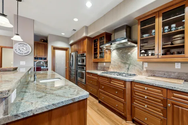 a kitchen with stainless steel appliances granite countertop a stove and a sink