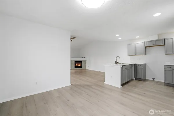 a view of a kitchen with a sink and a large window