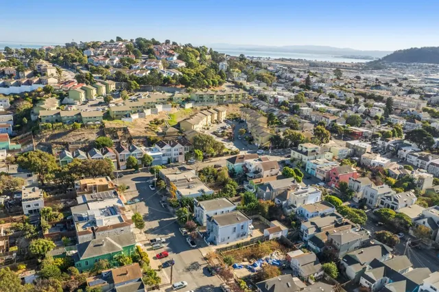 an aerial view of residential houses with city view