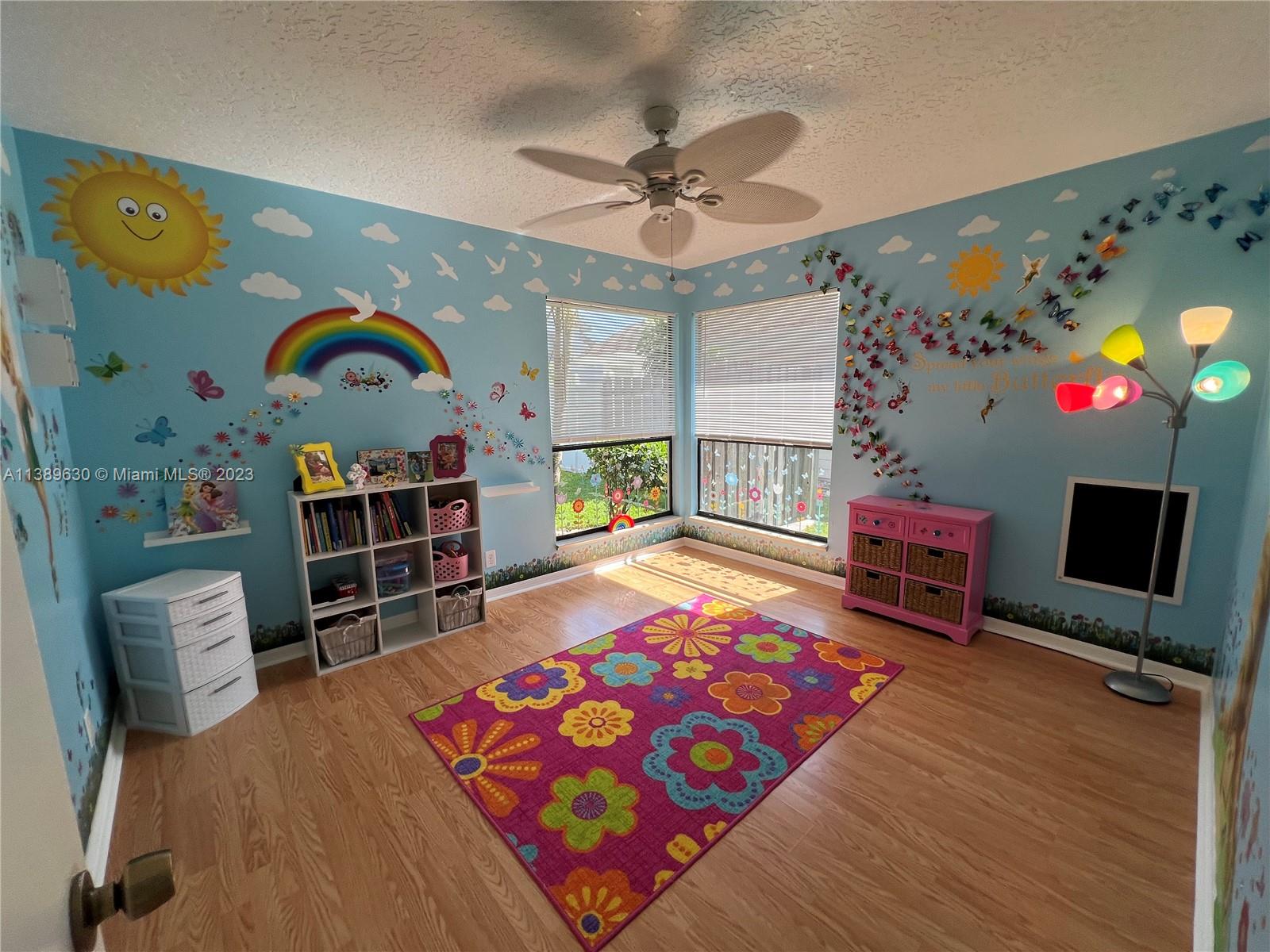 6159 Dimond Street Jupiter, FL 33458 - Photo 11 of 26 a bedroom with a bed bookshelf and a computer on a table in it
