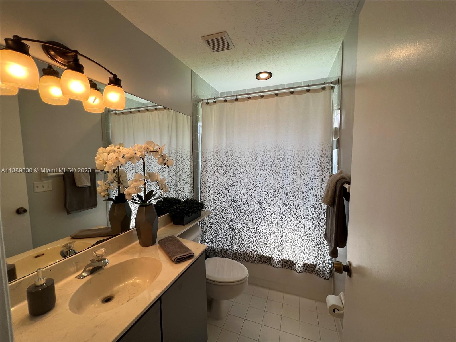 6159 Dimond Street Jupiter, FL 33458 - Photo 13 of 26 a bathroom with a sink toilet and shower