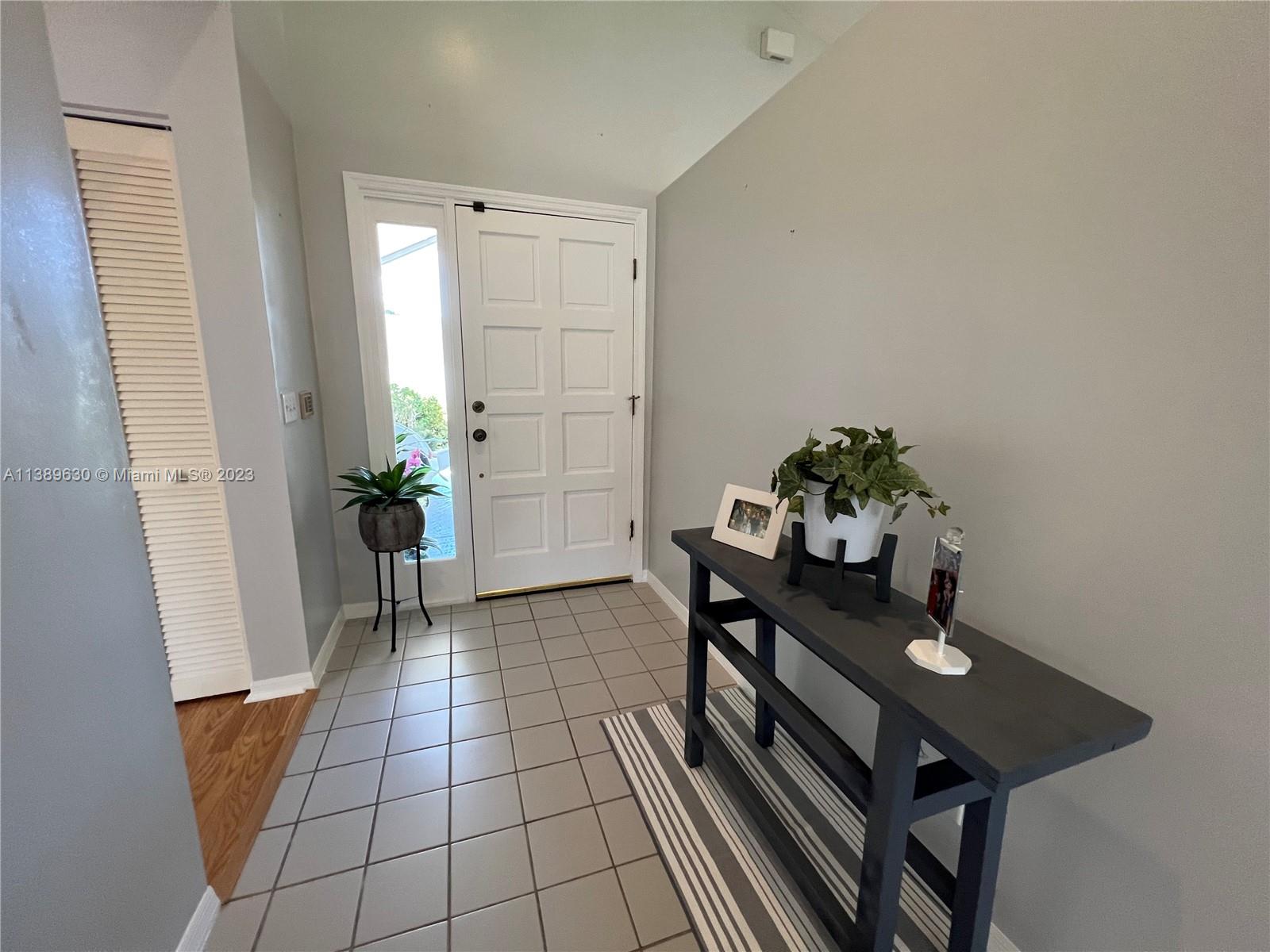 6159 Dimond Street Jupiter, FL 33458 - Photo 14 of 26 a dining room with furniture and flowers
