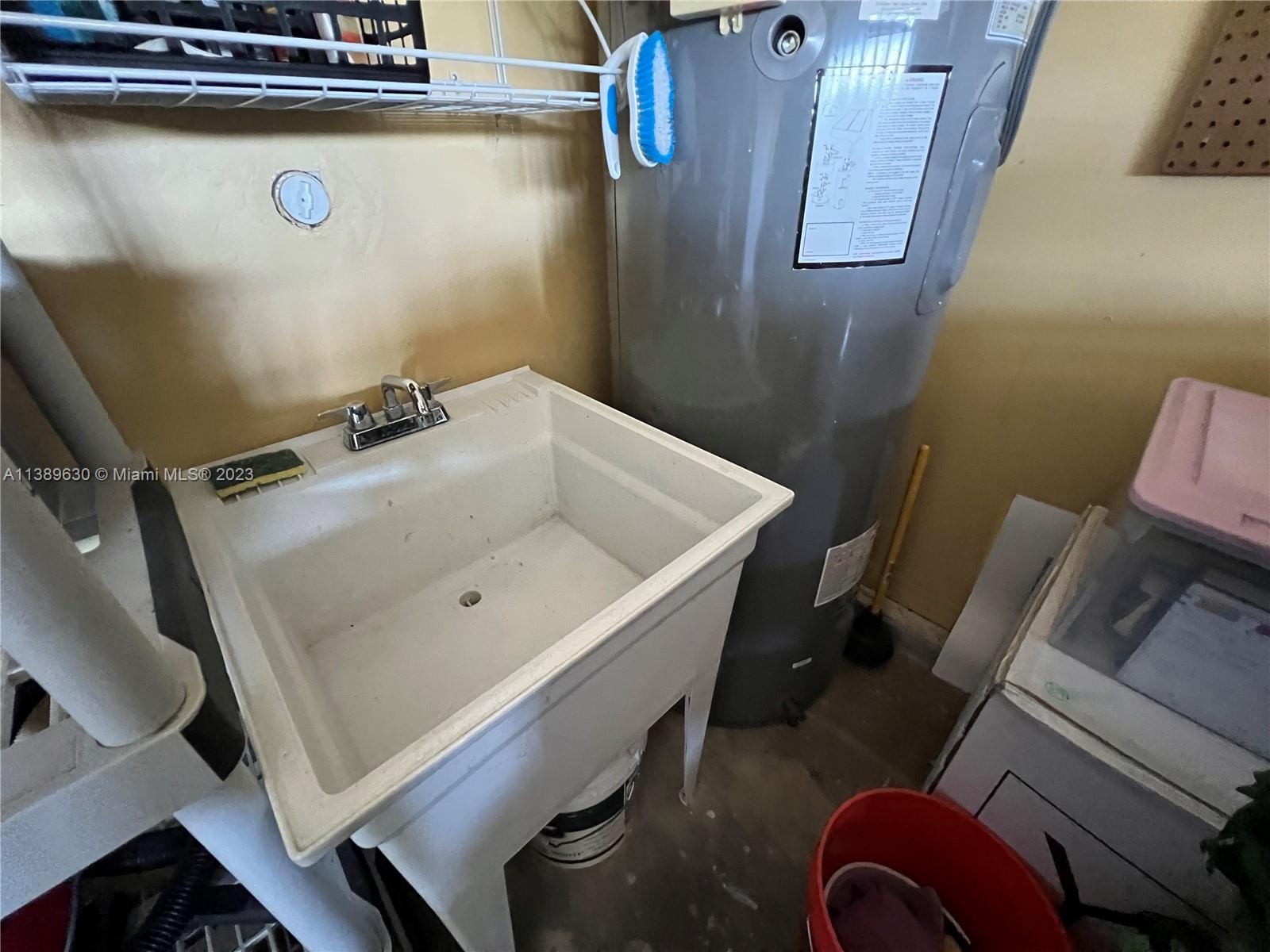 6159 Dimond Street Jupiter, FL 33458 - Photo 16 of 26 a bathroom with a sink and mirror