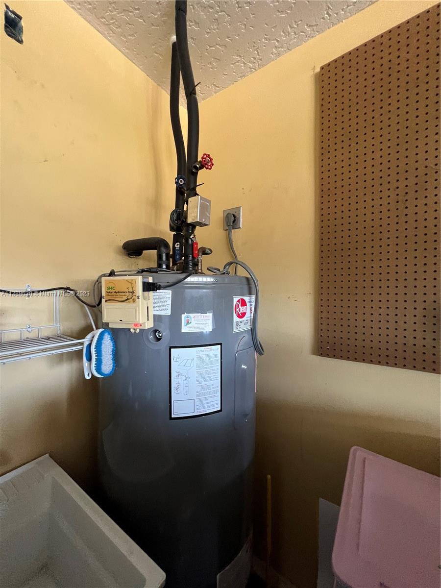 6159 Dimond Street Jupiter, FL 33458 - Photo 18 of 26 a view of storage and utility room with washer and dryer