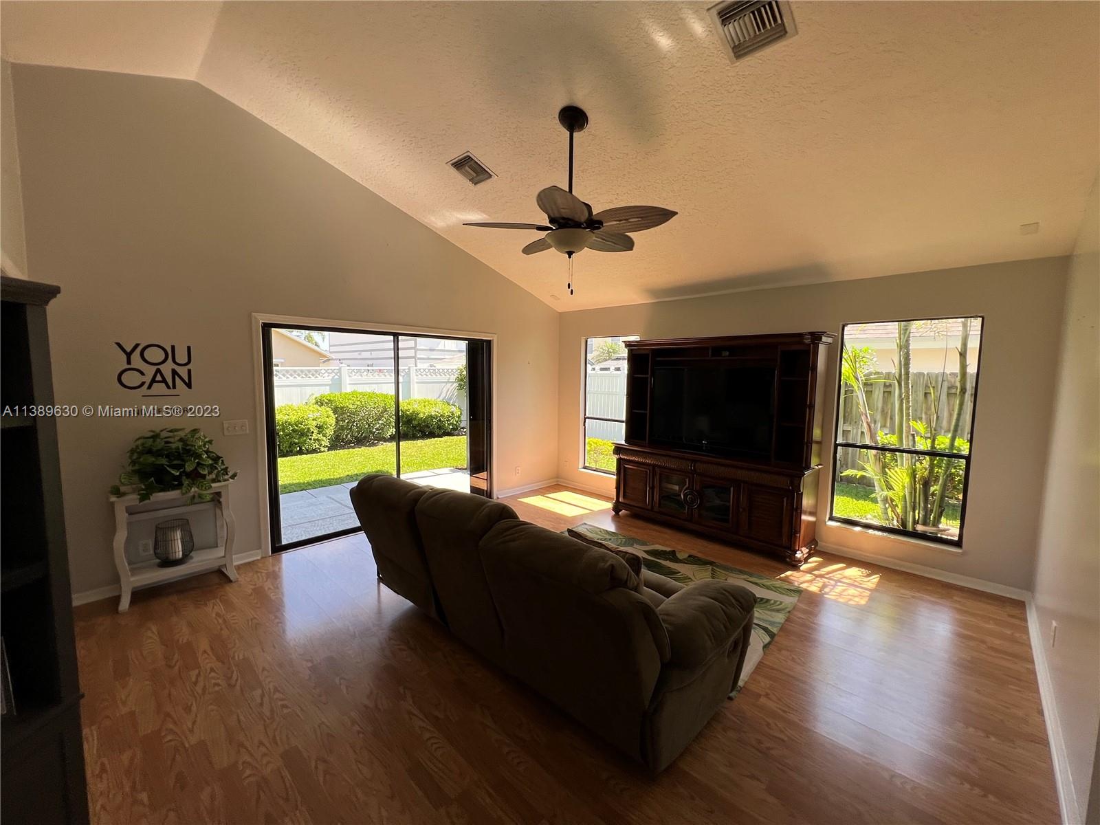 6159 Dimond Street Jupiter, FL 33458 - Photo 19 of 26 a living room with furniture tv and a flat screen tv