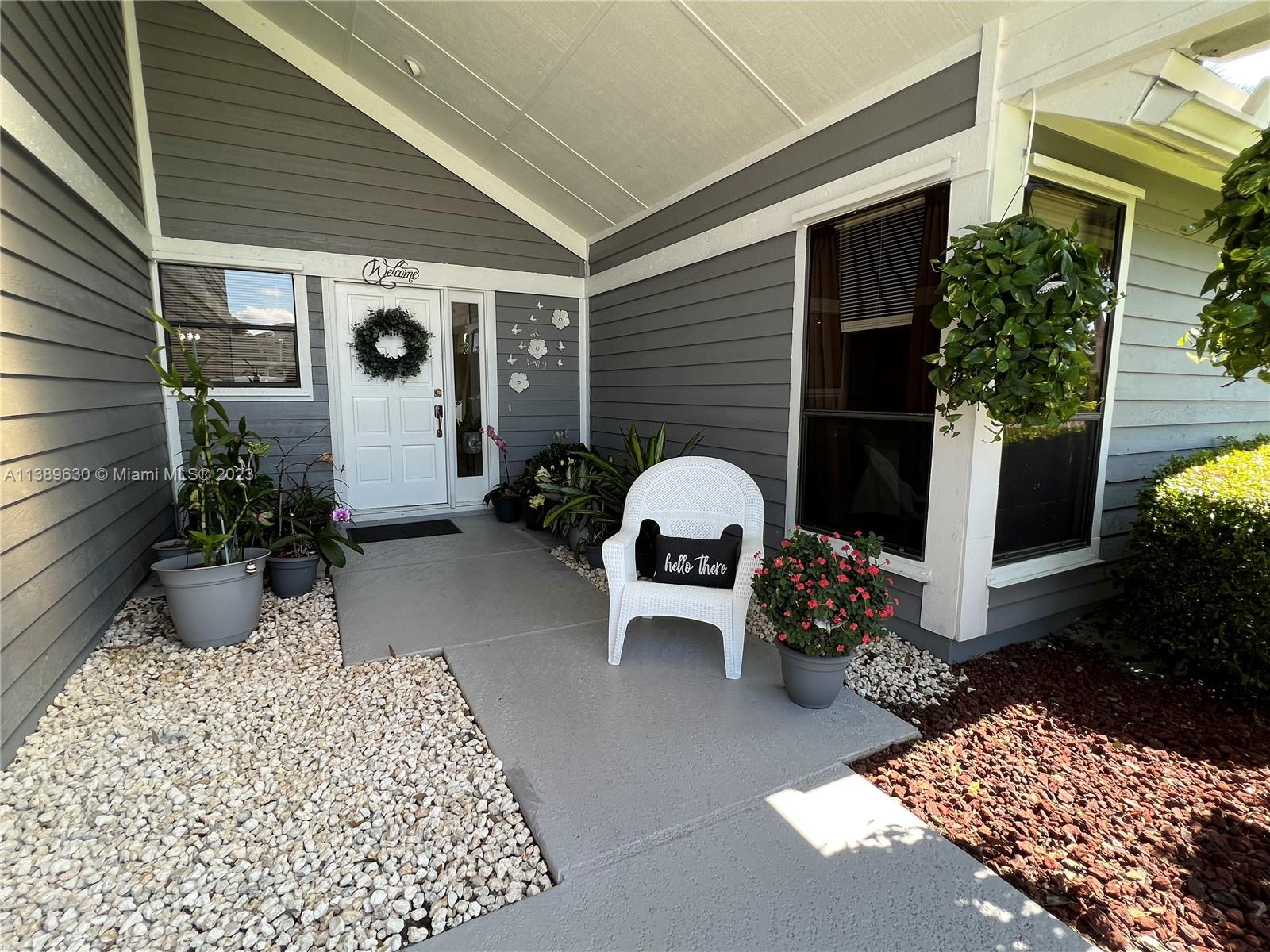 6159 Dimond Street Jupiter, FL 33458 - Photo 2 of 26 a view of a chairs and table in the patio