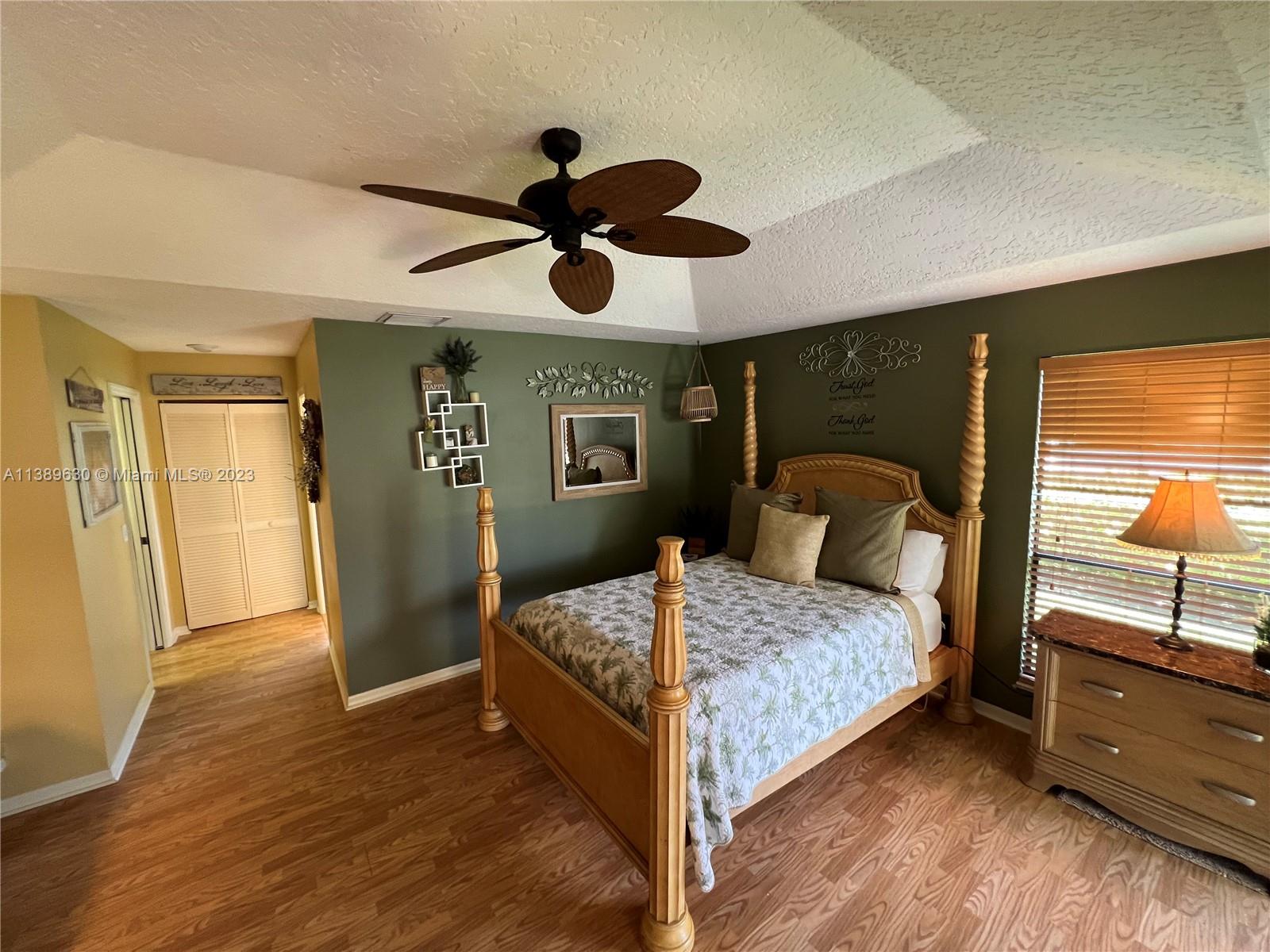 6159 Dimond Street Jupiter, FL 33458 - Photo 6 of 26 a bedroom with a bed and a walk in closet