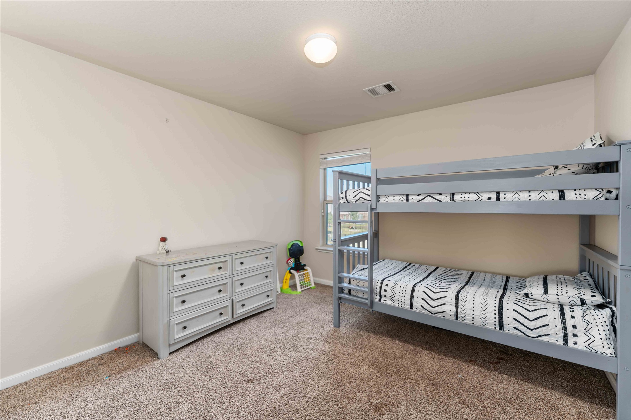 9902 Bezeled Cir Lane Rosharon, TX 77583 - Photo 16 of 29 a bedroom with a bed and a dresser