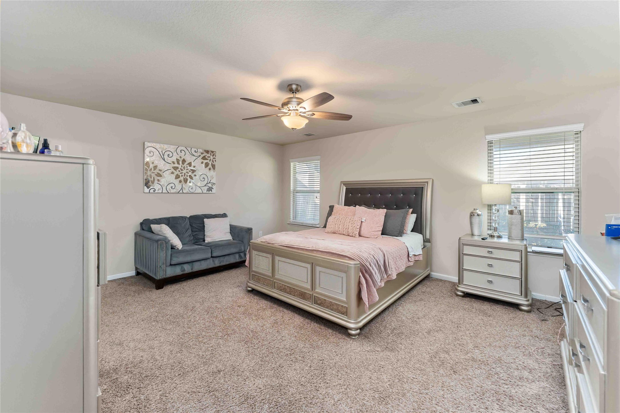9902 Bezeled Cir Lane Rosharon, TX 77583 - Photo 17 of 26 a bedroom with a bed couch and a ceiling fan