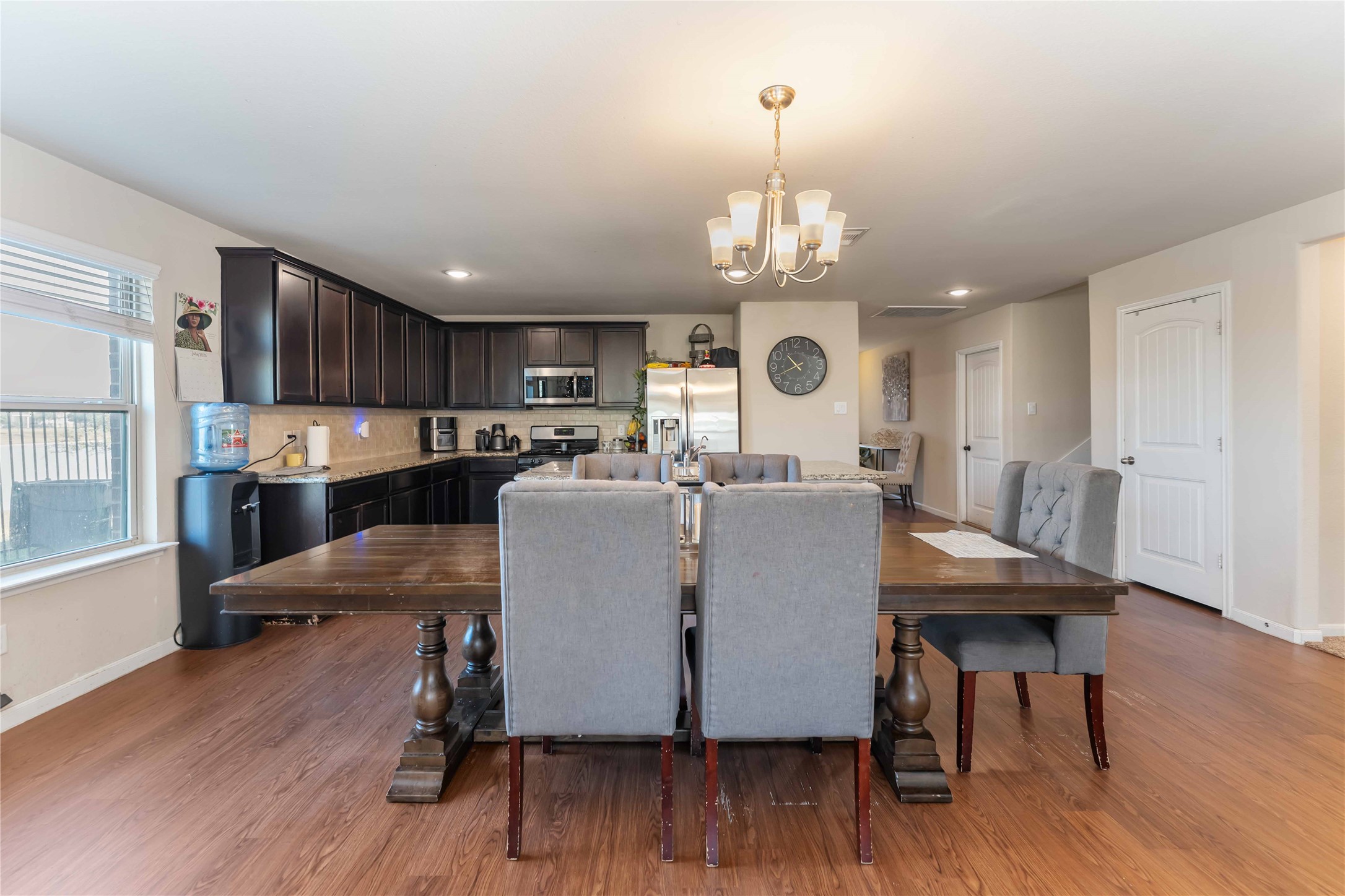 9902 Bezeled Cir Lane Rosharon, TX 77583 - Photo 7 of 29 a view of a dining room with furniture wooden floor and chandelier