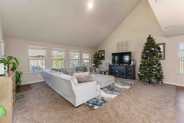 a living room with furniture a large window and a fireplace