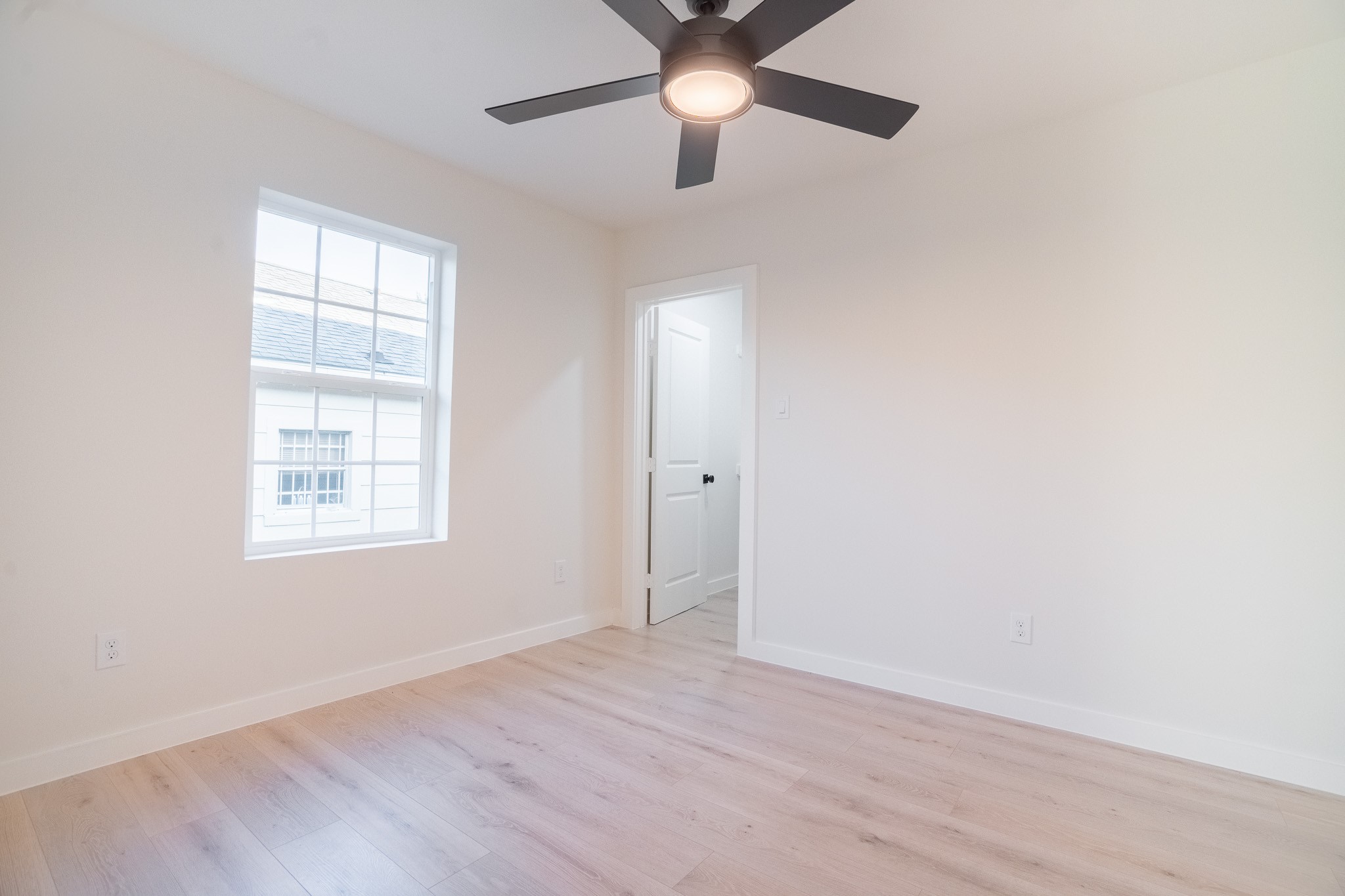 1310 East 34th Street Houston, TX 77022 - Photo 14 of 19 wooden floor in an empty room with a window