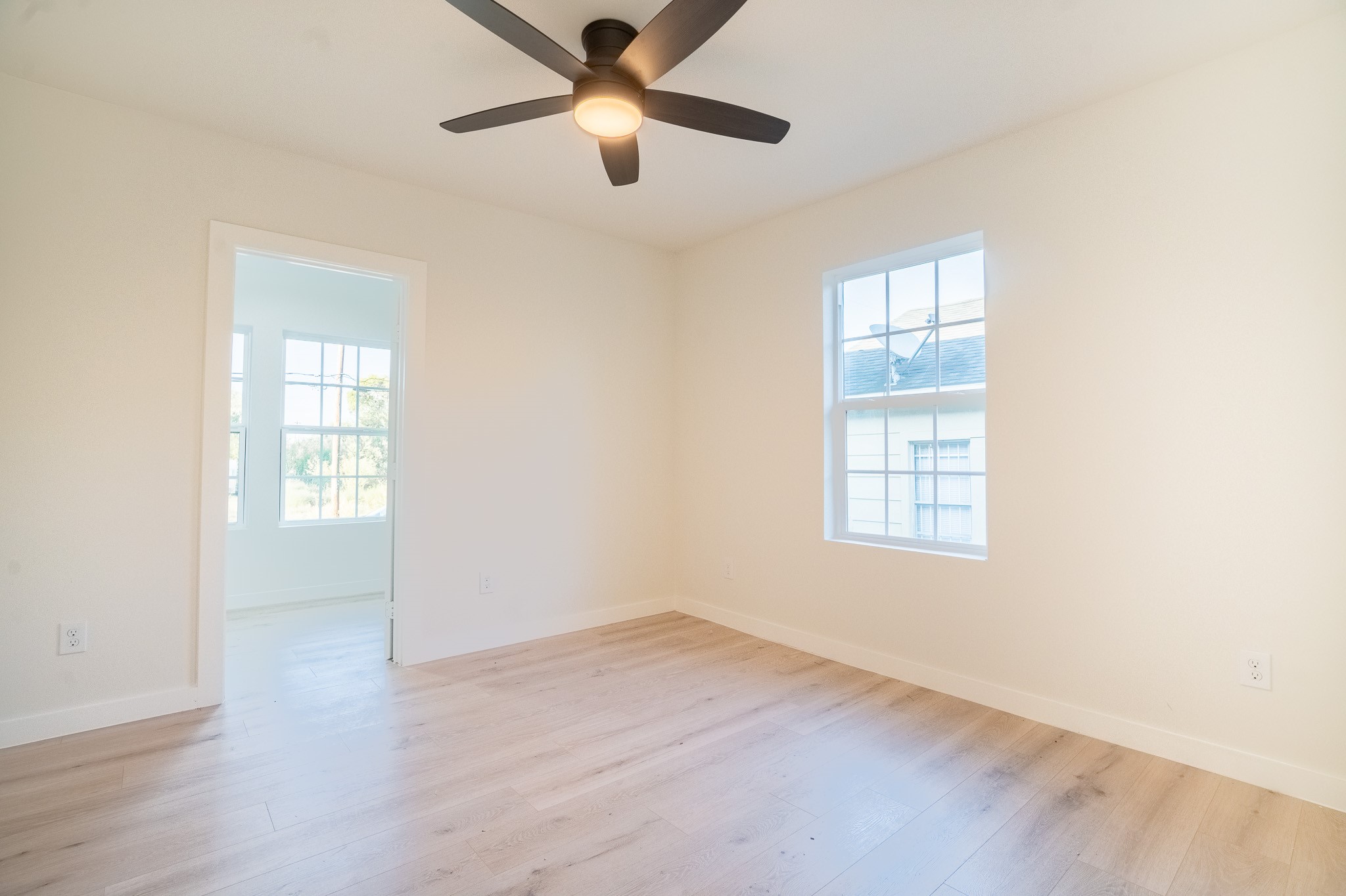 1310 East 34th Street Houston, TX 77022 - Photo 15 of 19 an empty room with wooden floor closet and windows