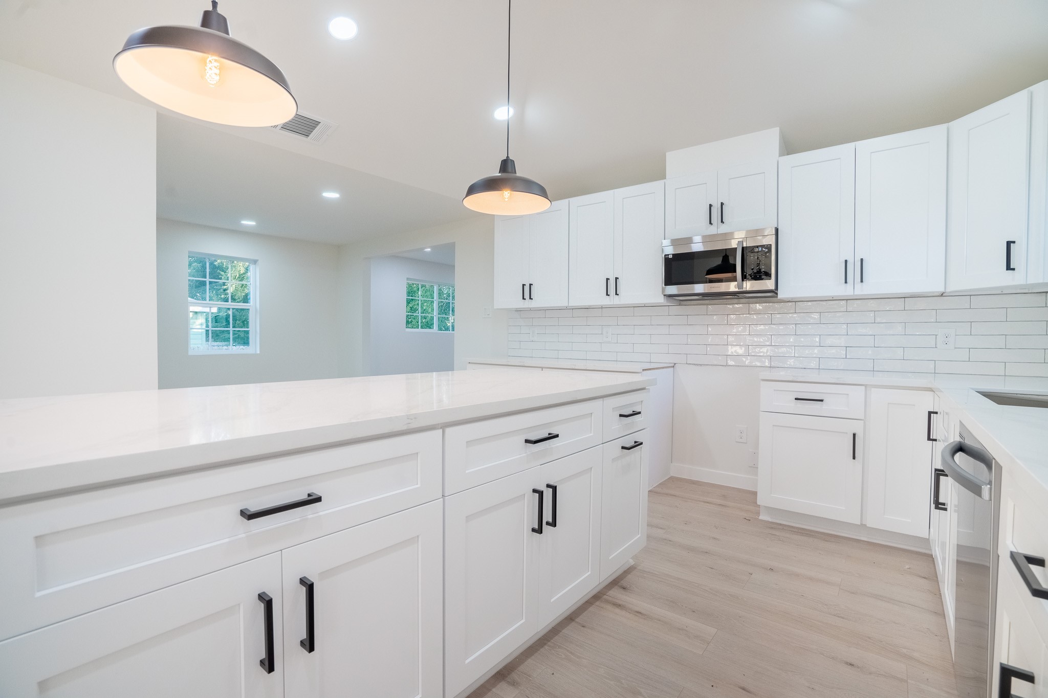 1310 East 34th Street Houston, TX 77022 - Photo 4 of 19 a kitchen with white cabinets stainless steel appliances and sink
