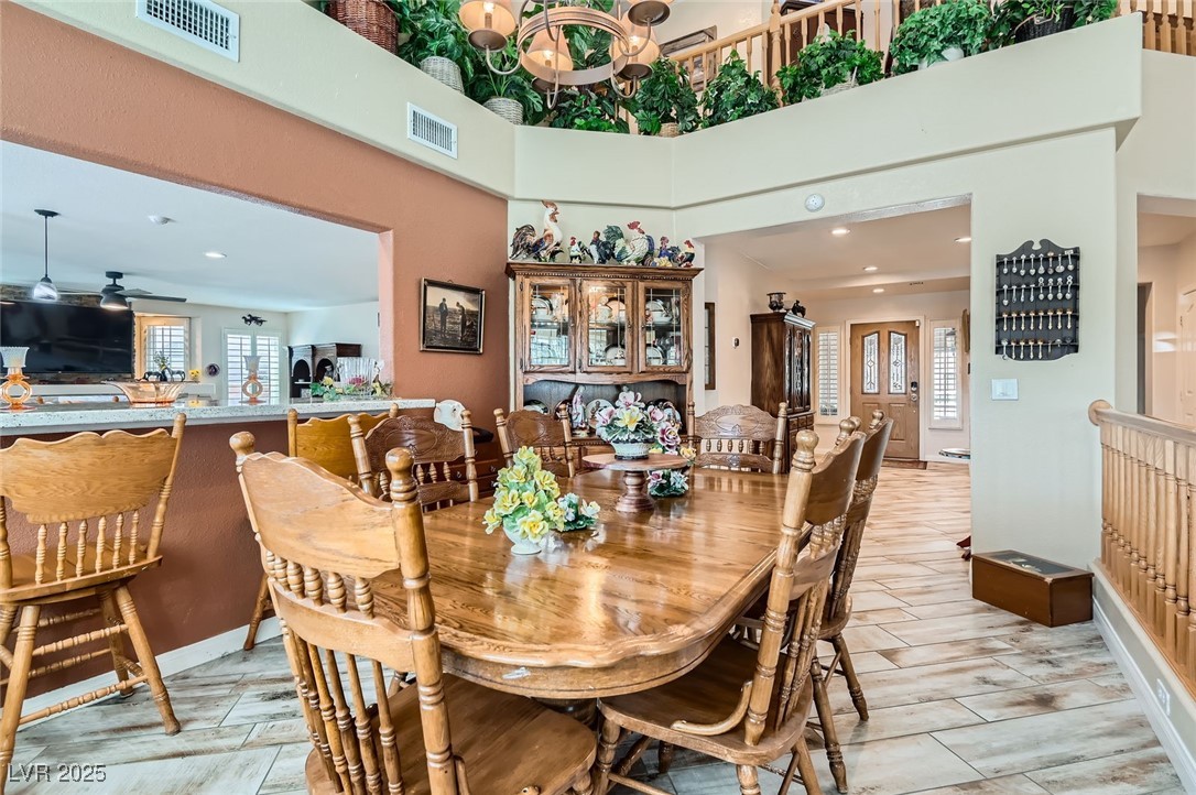 20 High Sierra Henderson, NV 89074 - Photo 15 of 53 Dining room featuring visible vents, an inviting chandelier, and a towering ceiling