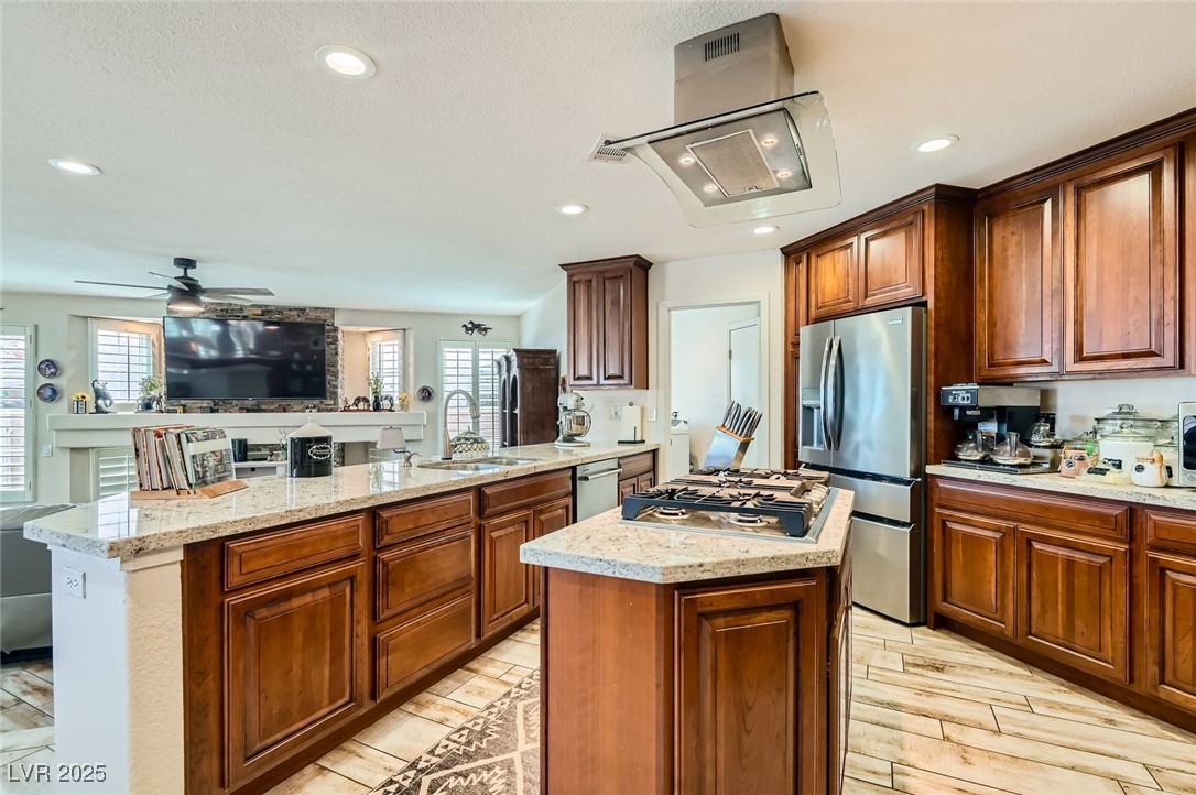 20 High Sierra Henderson, NV 89074 - Photo 19 of 53 Kitchen with a center island, ceiling fan, a peninsula, stainless steel appliances, and a sink