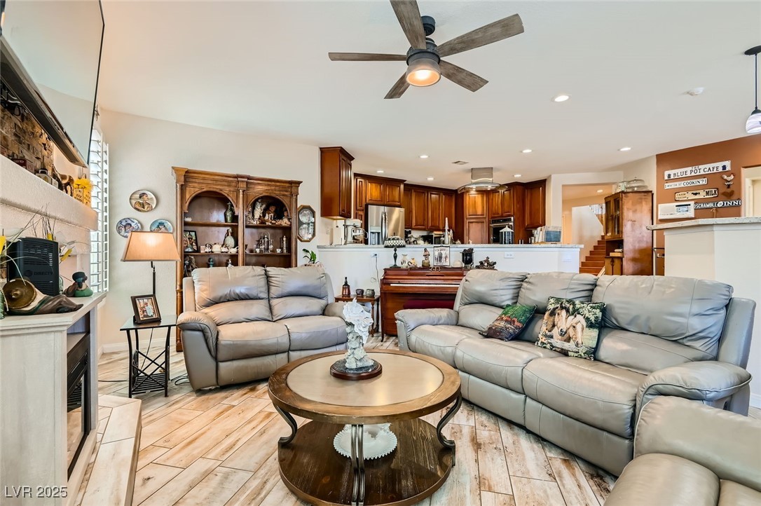 20 High Sierra Henderson, NV 89074 - Photo 24 of 53 Living room featuring a fireplace, light wood-style flooring, recessed lighting, and a ceiling fan