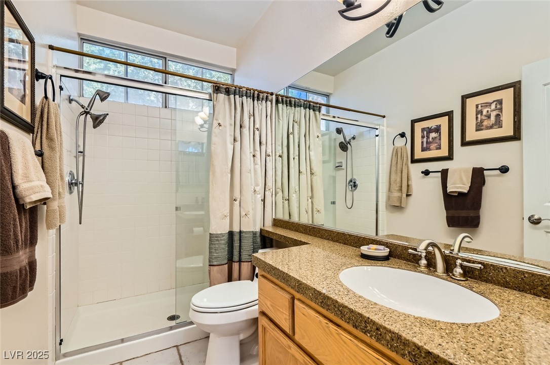 20 High Sierra Henderson, NV 89074 - Photo 27 of 53 Full bathroom with vanity, a shower stall, toilet, and tile patterned floors