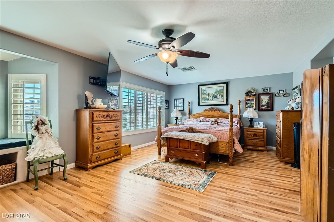 20 High Sierra Henderson, NV 89074 - Photo 28 of 53 Bedroom with a ceiling fan, light wood-style floors, visible vents, and baseboards