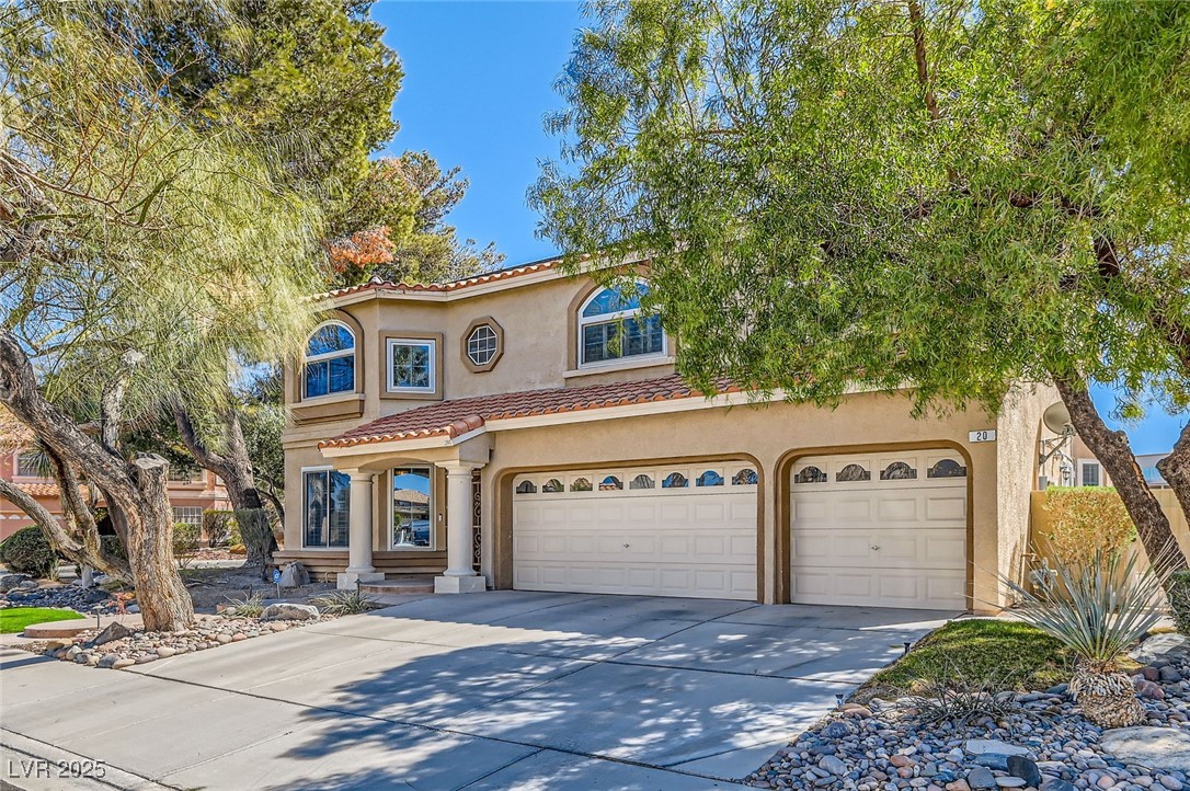 20 High Sierra Henderson, NV 89074 - Photo 3 of 53 Mediterranean / spanish house with a tile roof, concrete driveway, a garage, and stucco siding