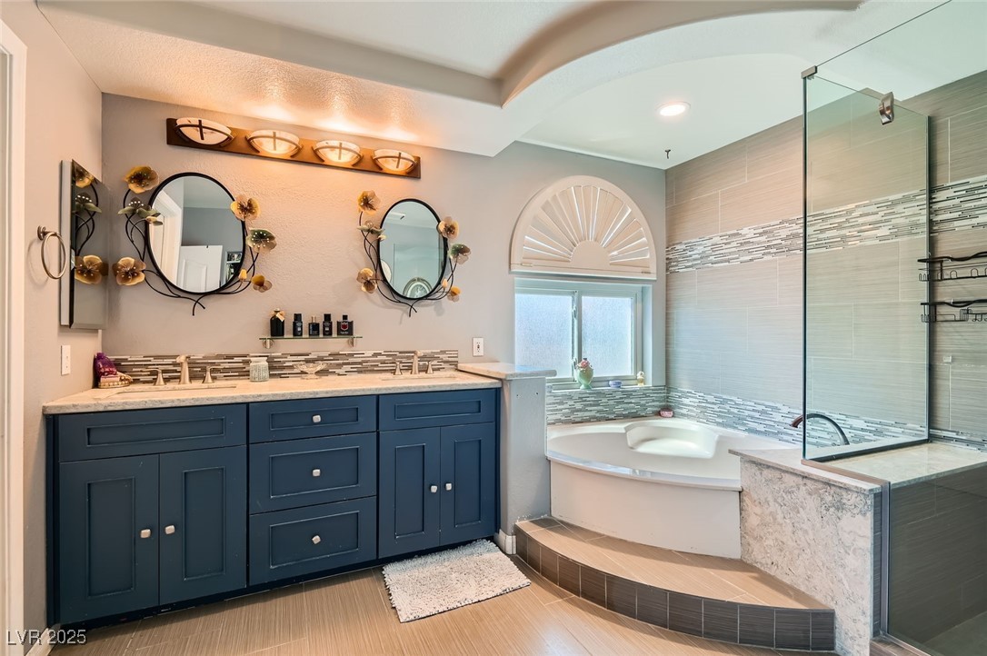 20 High Sierra Henderson, NV 89074 - Photo 33 of 53 Bathroom with a sink, a bath, double vanity, and a tile shower